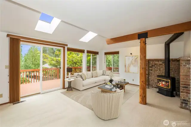 Living room or a great room has nice views out to the west, all while being warmed during the chilly winter months with your propane free standing stove. Virtual staging