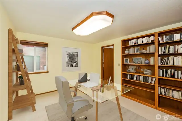Office area with a bath, or could this be the primary room on the main floor with a private bath, you can choose.  You can see the shop through the window.  Virtual staging