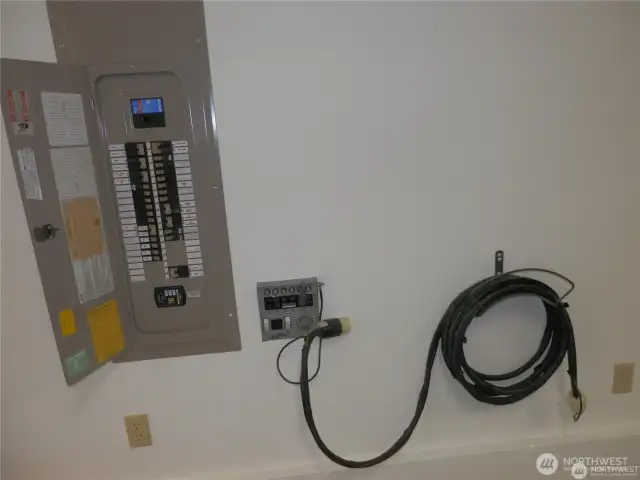 Going downstairs this panel has a hook-up for a backup generator with ground in garage.  Do you need an EV charger? 10 gage electrical wire and breaker have already been installed.