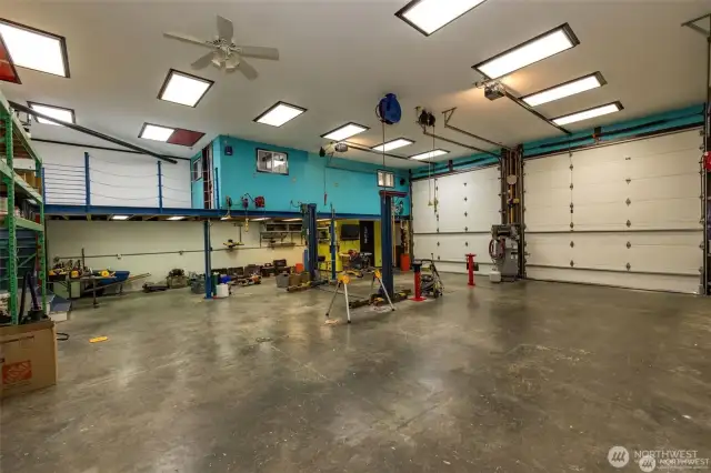 From the back NE corner of the 40' X 40' shop looking SW to the entry doors.  The turquoise color walls is the office above the 3/4 bath on the ground floor with the yellow colored walls.