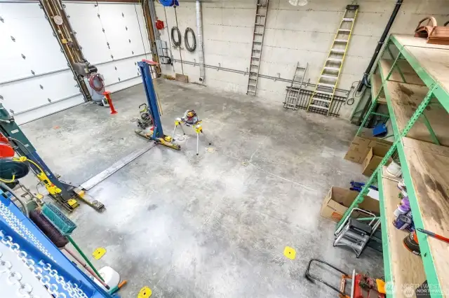 From the upper area looking down at huge floor space with commercial industrial grade metal shelving on left (back of the garage).  See the attached video for more details.