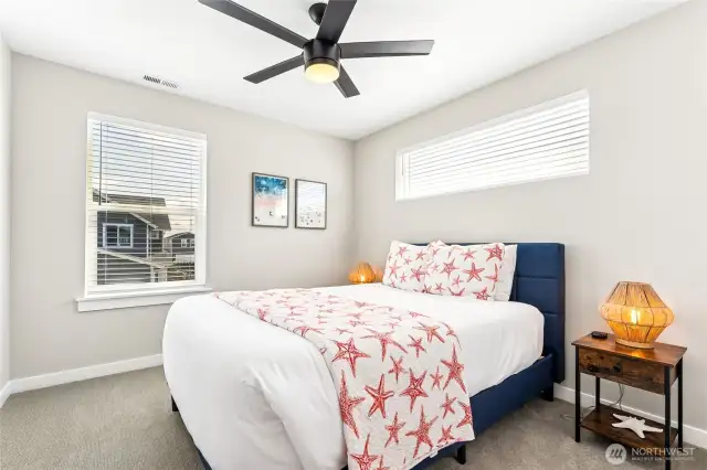 First guest room with a queen size bed