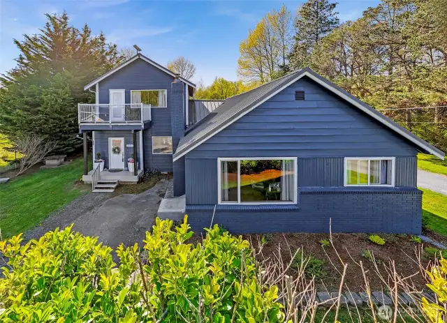 Freshly updated with striking blue cement plank siding, this beautifully renovated 1.5-story home sits on a generous 0.67-acre lot in Gooseberry Point.