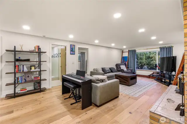 Cozy living area with wide-plank hardwoods, windows for natural light, and a reading nook.