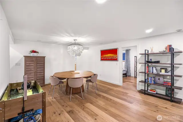 Welcoming dining room with engineered hardwoods and designer lighting.