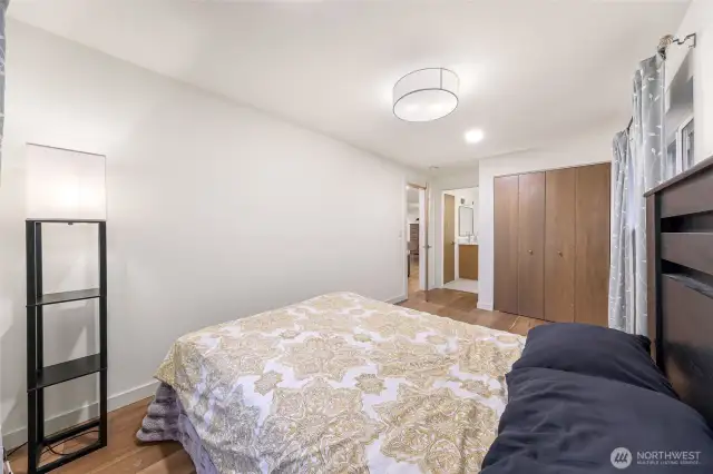 Bedroom includes closet and hardwood flooring.