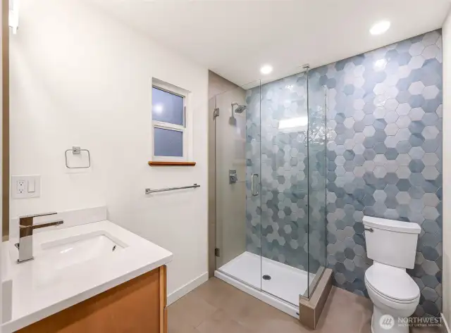 Spa-inspired bath with hex tile, floating
