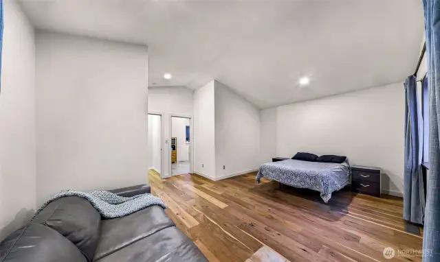 Wide plank floors and lounge area enhance this relaxing upper-level layout.