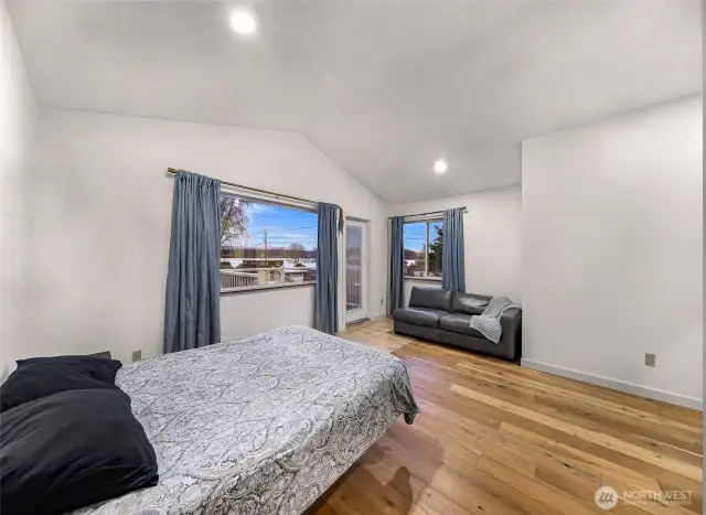 Primary suite includes a lounge-ready seating area and multiple windows.