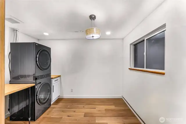 Utility room with high-efficiency LG appliances, butcher block counters, and workspace.
