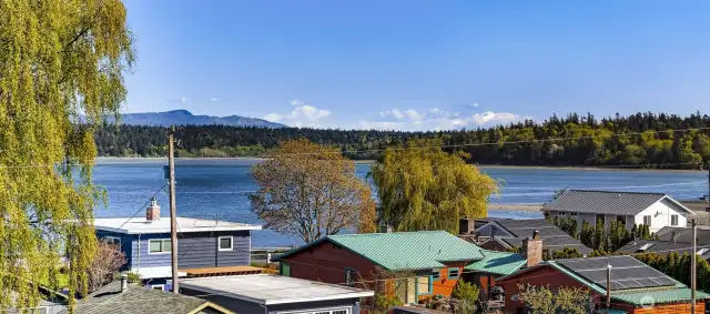 Upper balcony offers unobstructed views of bay and forested shoreline.