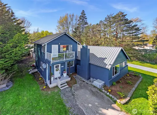 Appreciate the newly installed metal roof, clean landscaping, and expanded driveway—showcasing curb appeal and long-term investment.