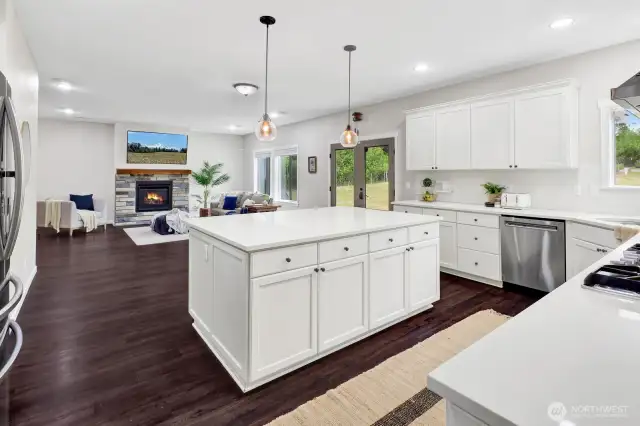 The kitchen is open to a large family room with gas fireplace and access to the backyard