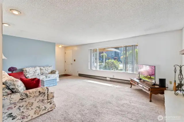 Standing in dining room looking into living room and entry of home