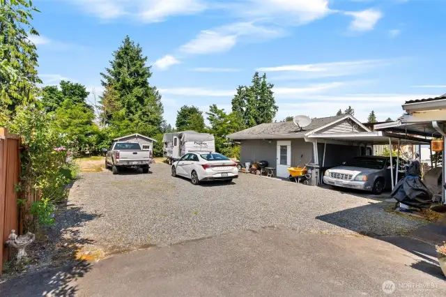Plenty of parking space with detached workshop/storage and carport