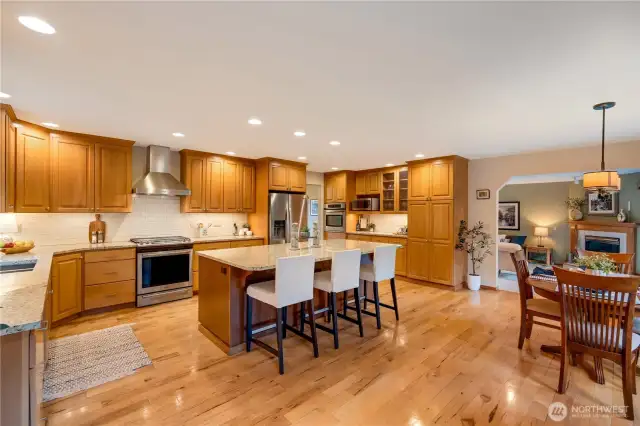 Chef-inspired kitchen with center island, and hardwood floors—perfect for gatherings in your Maple Valley home.