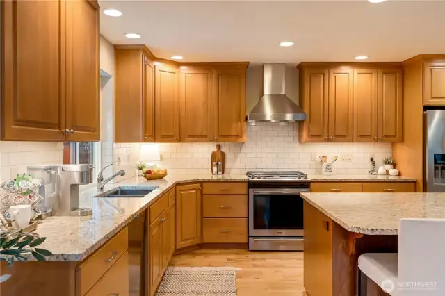 Warm wood cabinetry, granite countertops, and stainless appliances make this Maple Valley kitchen both beautiful and functional.