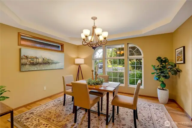 Bright and cheerful dining room surrounded by windows—start your day with nature views and natural light.