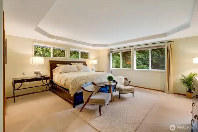 Expansive primary suite with tray ceilings and tranquil views—your personal retreat in Maple Valley real estate.