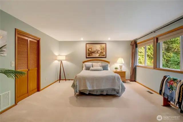 Large guest or secondary bedroom with peaceful views and plush carpeting in this 98038 home.