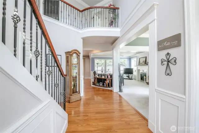 Radius upper floor railing and inviting entry into great room and dining room.