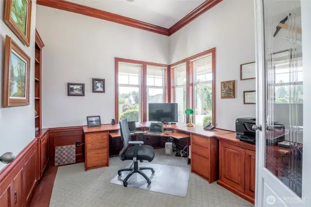 Main floor den with inlay carpet and custom built in cabinets with chair rail and shadow box detail.