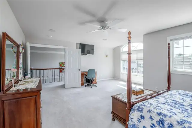 Primary bedroom with french doors and sitting area.