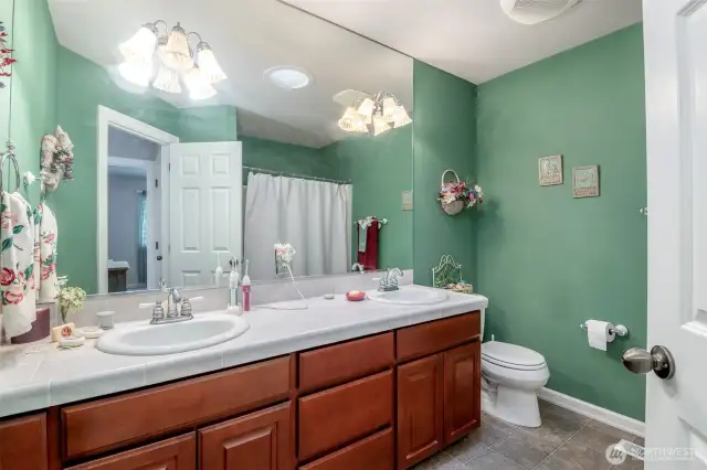 Large secondary bathroom with two sinks