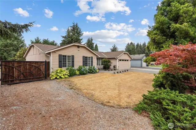 Oversized driveway with gate access and RV parking on both sides of the home.