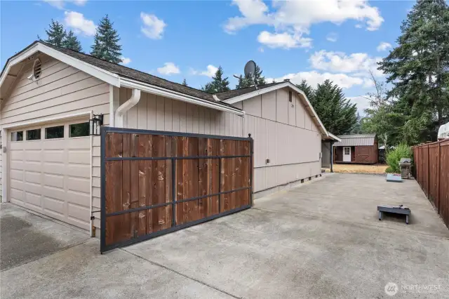 Side of the home, offering gate access, RV parking and hot tub hookups.