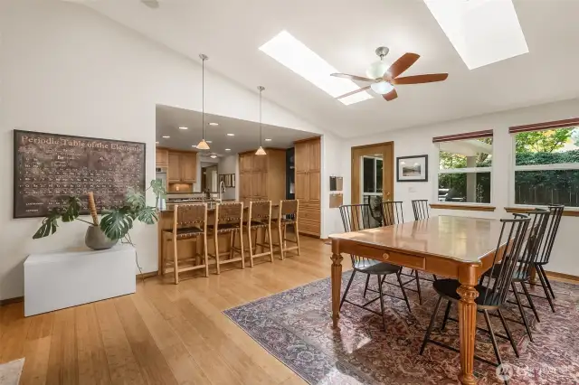 The dining room looks out to the backyard and benefits from vaulted ceilings, skylights and space for any occasion!