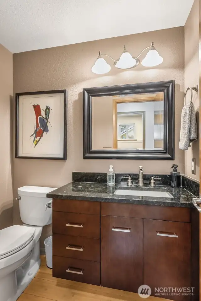Just behind the family room is the powder room on the first floor. It is also just inside from the 3 car garage and across the hall from the laundry room.
