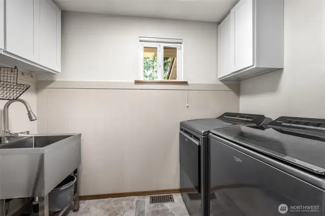 Laundry room is on the first floor, just inside from the garage and across the hall from the powder room.