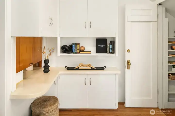 Foyer area with custom built-in storage and entrance to semi finished basement.