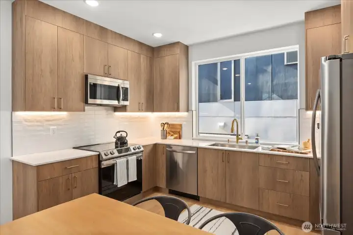 Thoughtfully designed kitchen boasts premium stainless appliances, custom cabinetry, and seamless modern finishes.