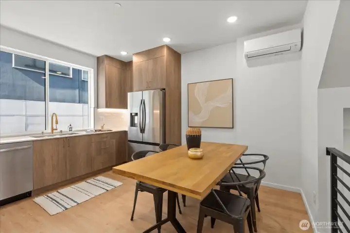 A spacious eat-in kitchen offers a stylish blend of wood textures, modern lighting, and open flow for entertaining.