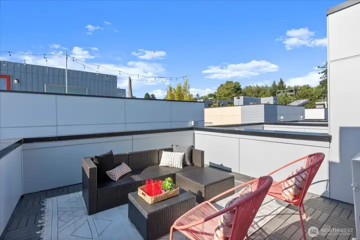 Host under the stars or unwind in style on the private rooftop deck with ample lounge seating and sweeping neighborhood views.