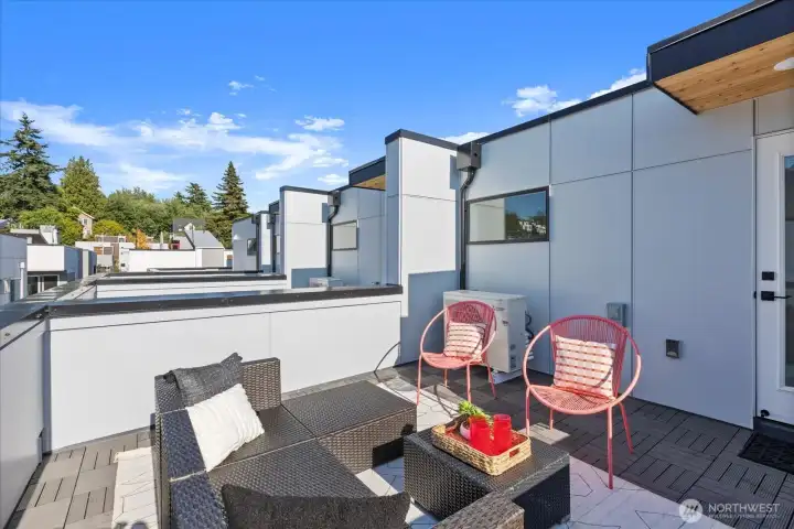 Enjoy indoor-outdoor living with this spacious rooftop deck framed by cityscapes and tree-lined views in every direction.