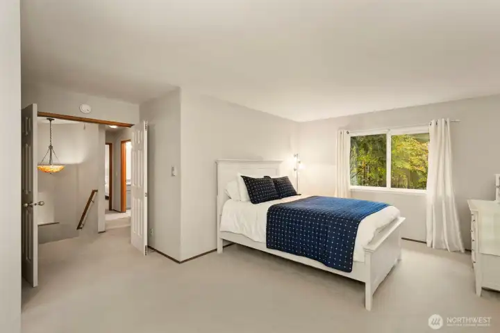 Another shot of primary bedroom with double doors.