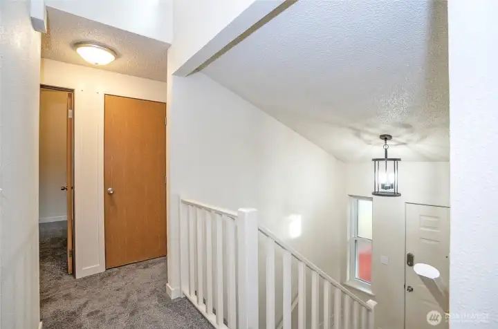 Upper level landing connecting two bedrooms and full bathroom.