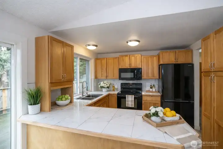 Kitchen highlights include gorgeous cabinets, countertops, and a welcoming eating bar for meals and conversation.
