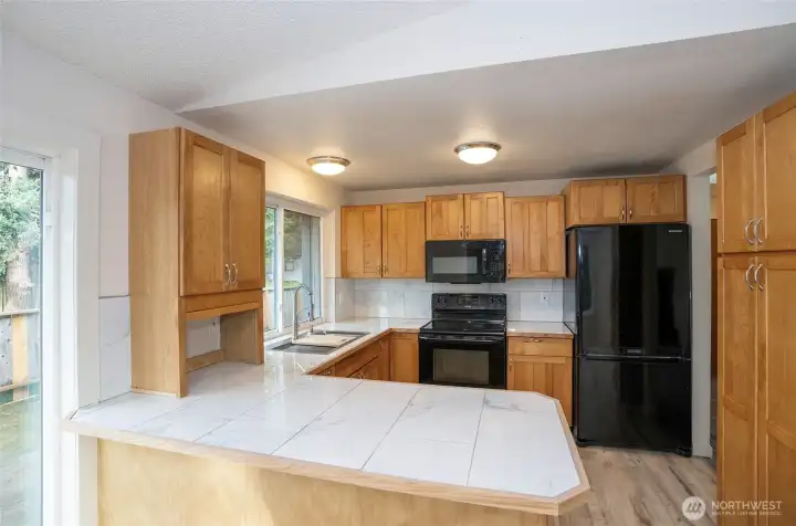 Kitchen highlights include gorgeous cabinets, countertops, and a welcoming eating bar for meals and conversation.