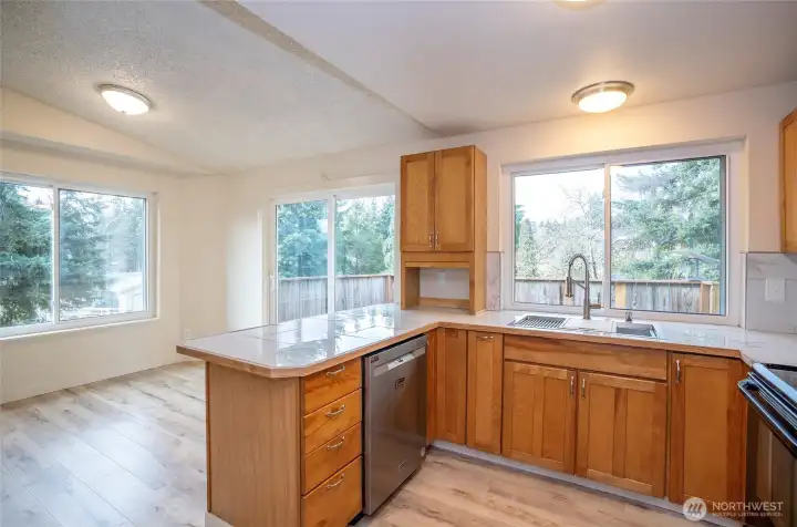Bright kitchen overlooking the dining area, enhanced by generous windows.