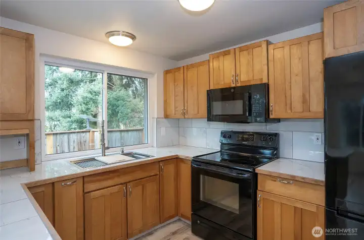 Large kitchen window above the sink brightens the space with natural light.