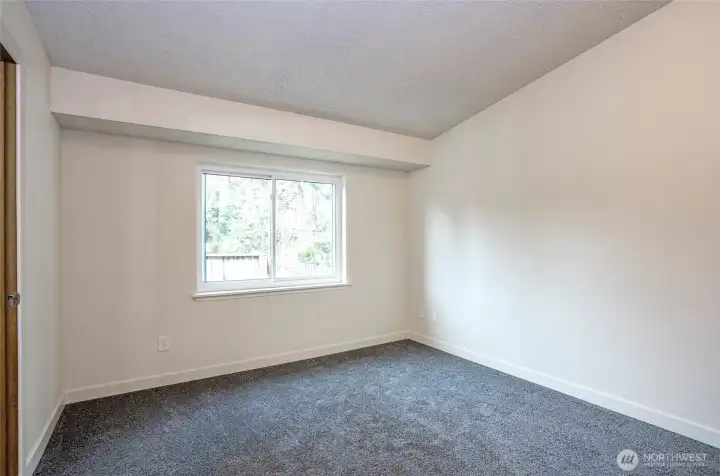 Beautifully updated upper-level primary suite with new carpet and a light-filled, updated window.