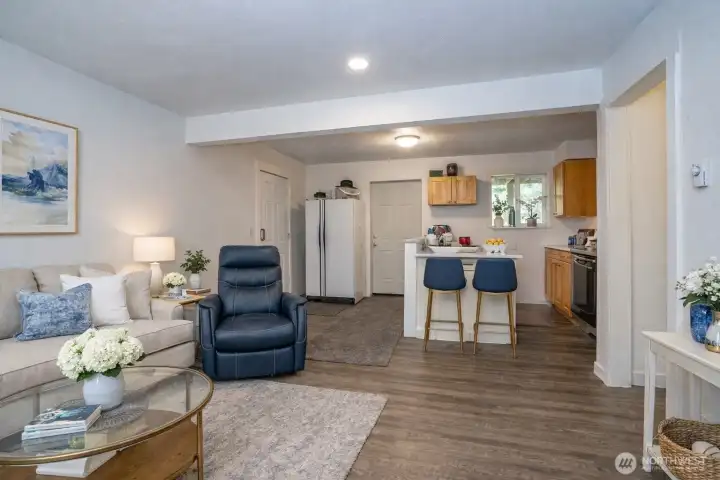 The lower-level mother-in-law suite overlooks the kitchen area. The left door serves as the main exterior entrance, while the rear door opens to the lower-level deck.