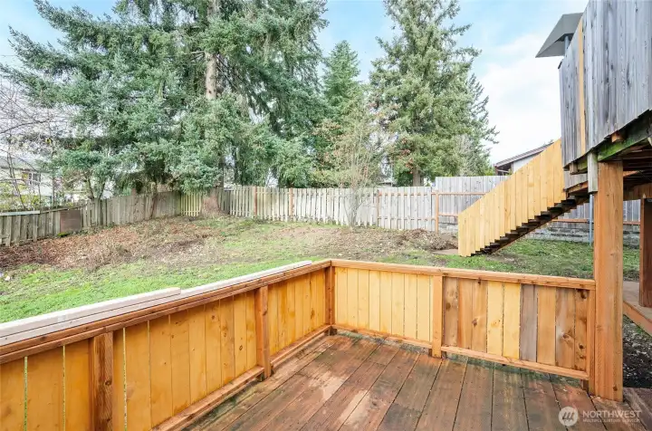 View of the fenced backyard from the lower-level deck.