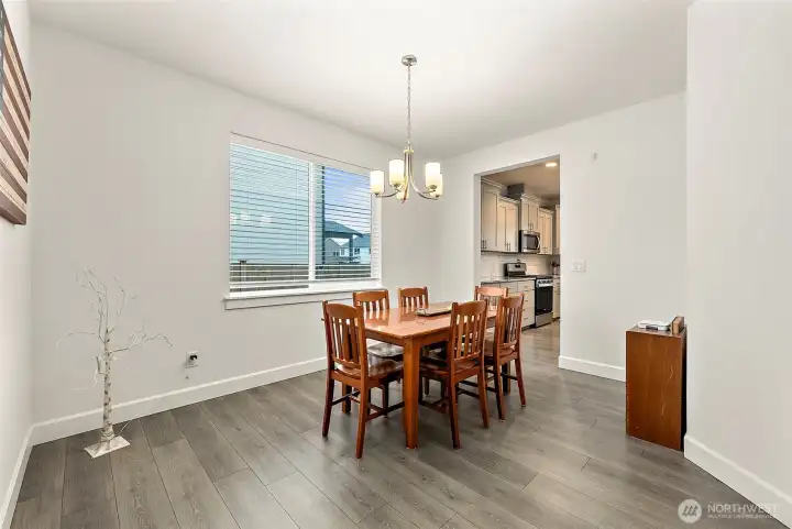 Open dining area leading to a kitchen with its own spacious eating area.