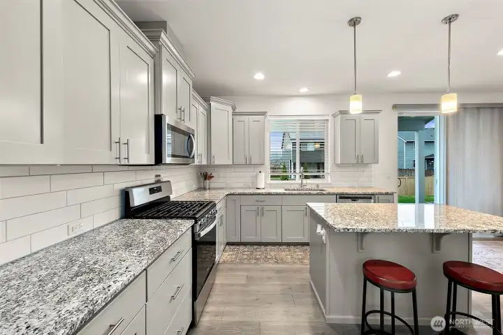 This kitchen is spacious, has gorgeous cabinetry, large island area, lots of counter space.  It's wonderful!