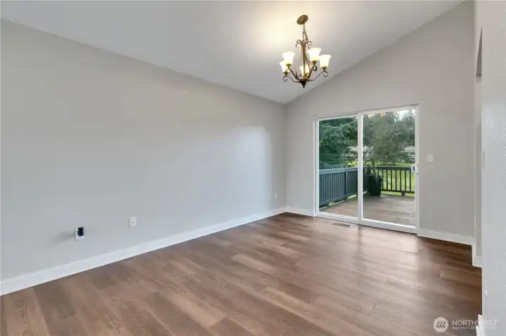 Dining area with chandelier lighting and sliding door to the rear deck.
